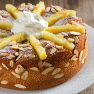 Batter preparation for pineapple almond cake with fresh ingredients.