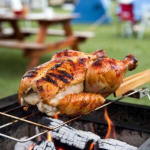   Basting grilled chicken with barbecue sauce